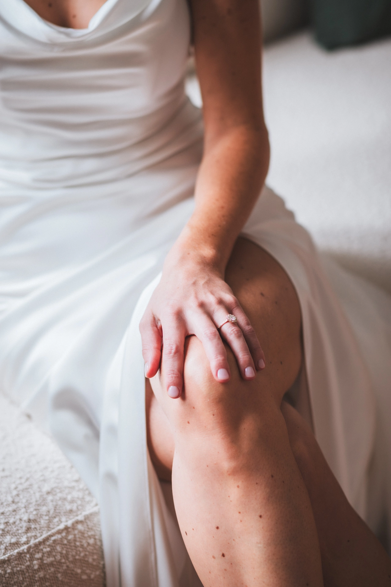 Détail de la main de la mariée, avec sa bague de fiançailles, pendant ses préparatifs au château Larteau en Gironde, par une photographe de mariages colorés.