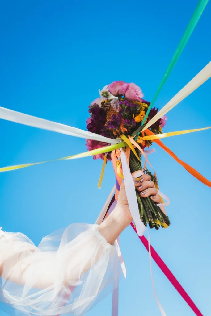 Détail du bouquet de la mariée lors du jeu des rubans pendant un mariage au domaine de Badine en Gironde.