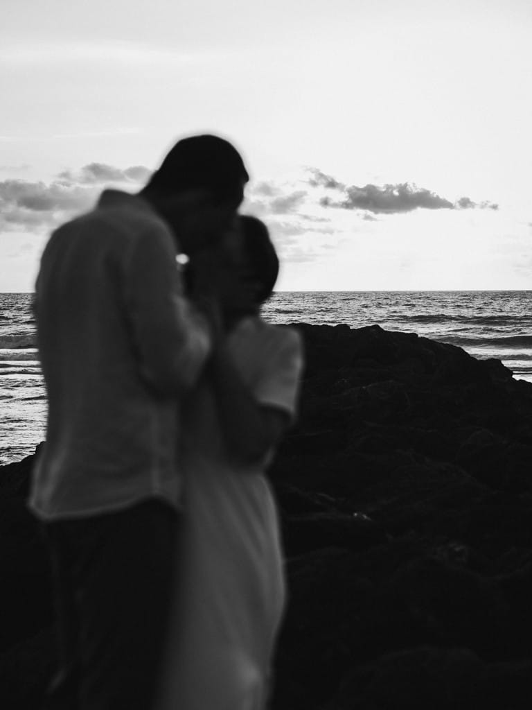 Le couple s'embrasse avec l'océan en arrière plan dans les Landes