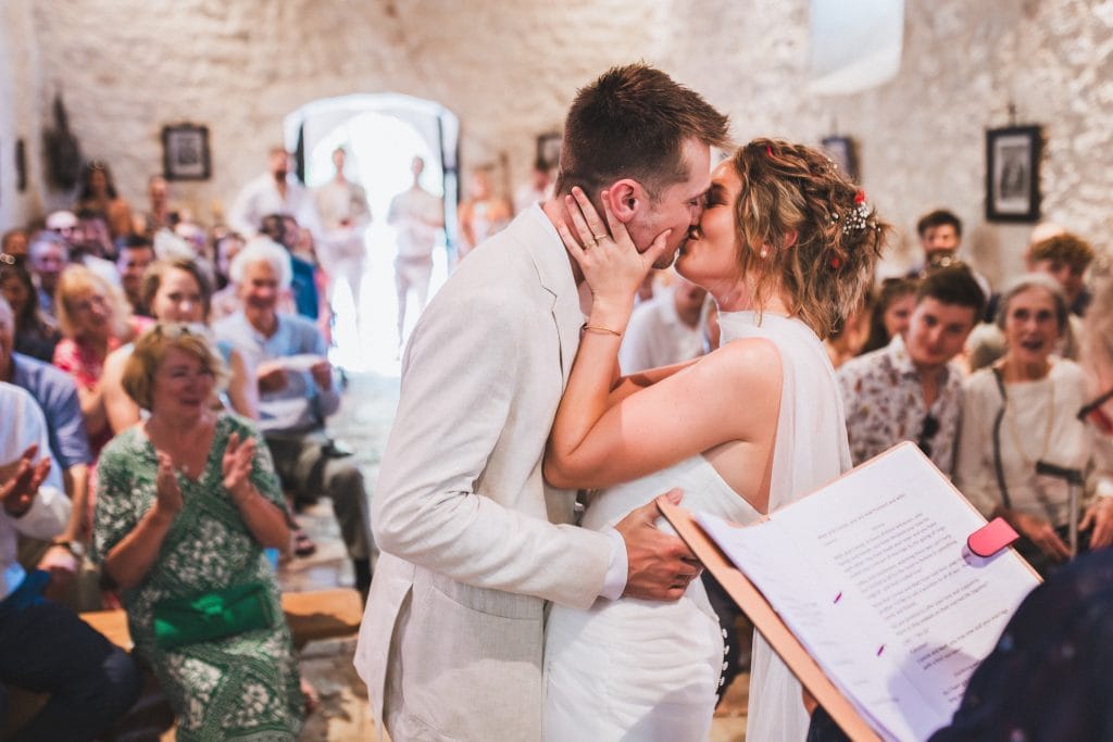 Les mariés s'embrassent et se disent oui pour la vie lors de leur cérémonie de mariage au château Sainte-Foy